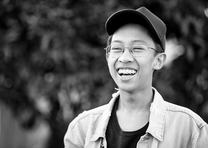 young man smiling with braces not worrying about insurance