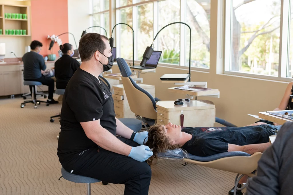 Dr. Joseph Phillips working with a patient in the clinic at Phillips Family Orthodontics