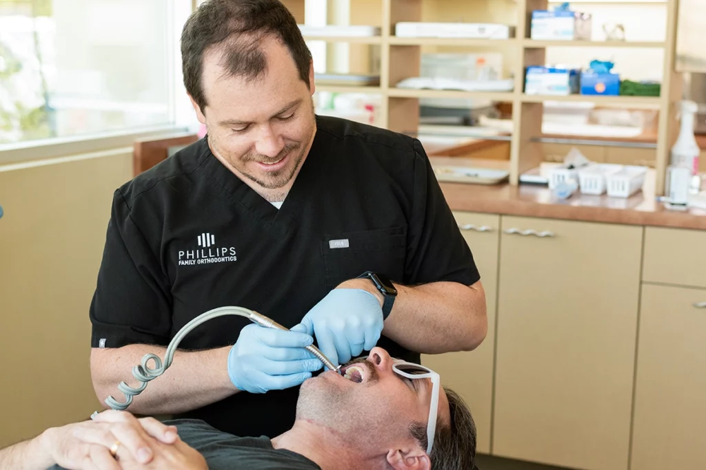 Dr. Joseph Phillips installing a palatal expansion device on an adult patient at Phillips Family Orthodontics