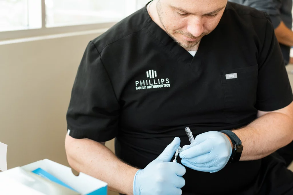 Orthodontist adjusting Invisalign for adults aligners for a perfect fit.