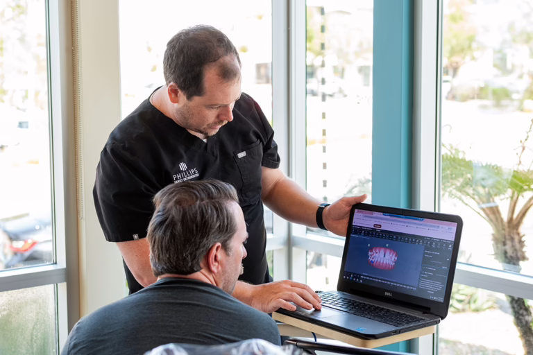 Dr. Joseph Phillips discussing Invisalign and clear aligner questions with a patient at Phillips Family Orthodontics