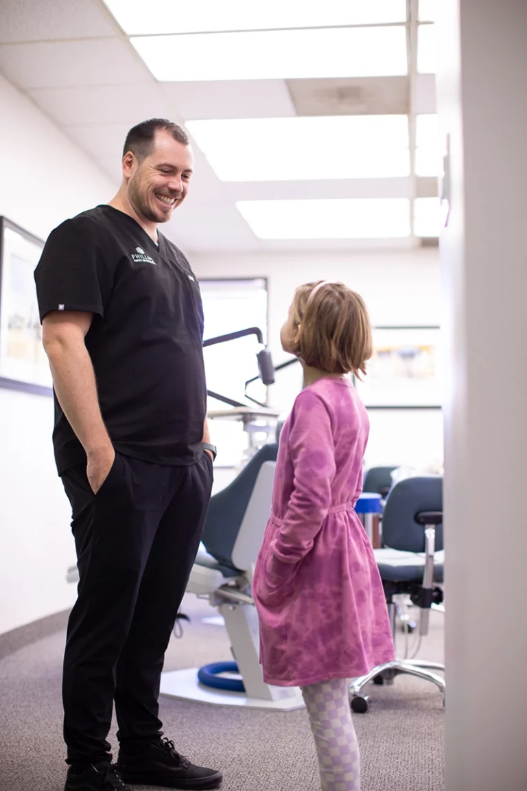 Dr. Joseph Phillips laughing with a child patient during a consultation at Phillips Family Orthodontics