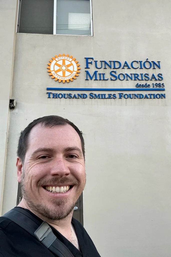 Dr. Joseph Phillips taking a selfie in front of the Thousand Smiles Clinic in Ensenada, a free clinic for cleft lip and palate patients