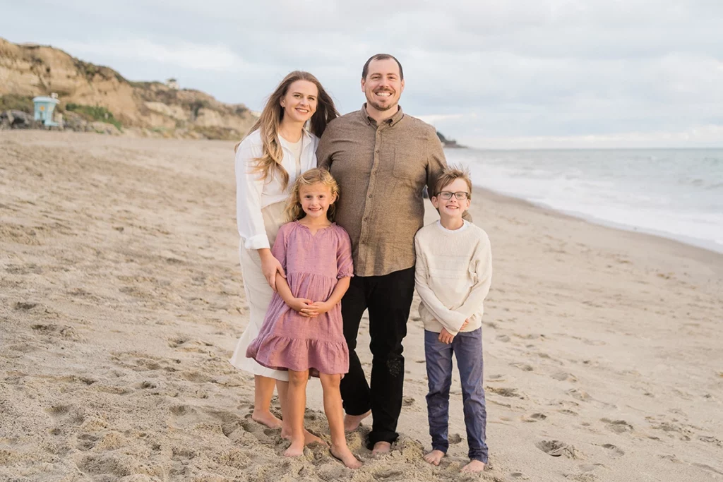 Dr. Joseph Phillips with his family on the beach in Encinitas, smiling and enjoying time together