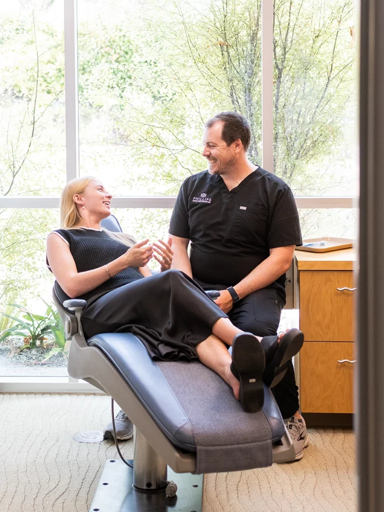 Dr. Joseph Phillips consults with patient in his Encinitas orthodontics office. Contact us for a free consultation